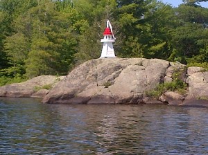 red and white lighthouse on a rock